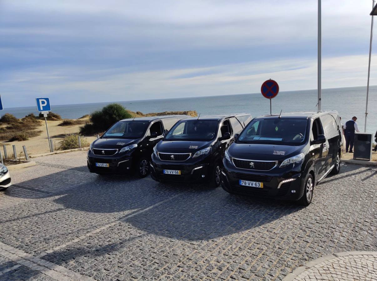 Three Fat Cats Peugeot Traveller vans lined up by the Algarve coast